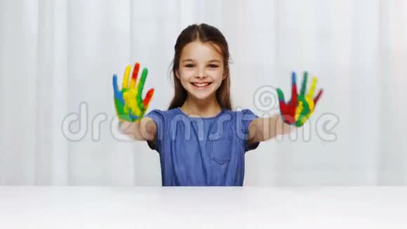 微笑的女孩表现出彩绘的手视频的预览图