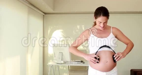 带耳机的孕妇视频的预览图