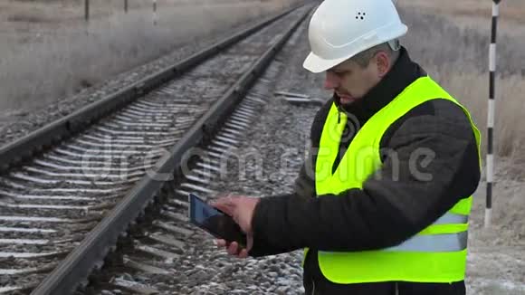 在铁路附近有平板电脑的工人视频的预览图
