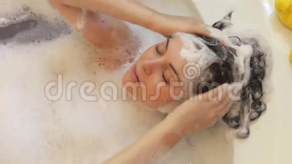 放松的女人躺在泡泡里视频的预览图