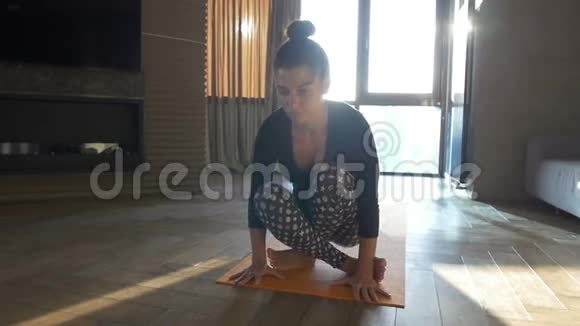 快乐美丽的女人在家做瑜伽运动视频的预览图