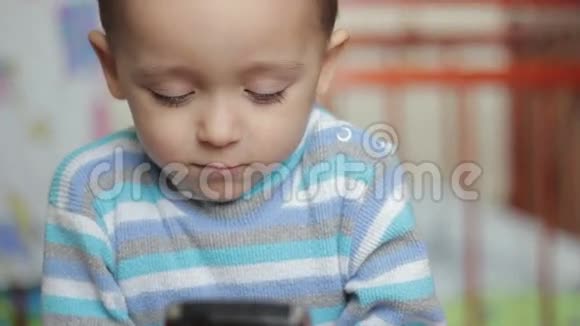 小男孩在玩智能手机视频的预览图