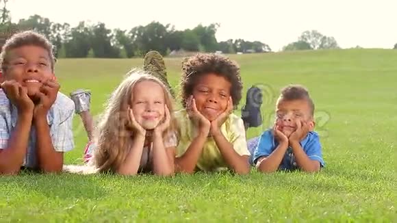 绿草上四个快乐的孩子视频的预览图