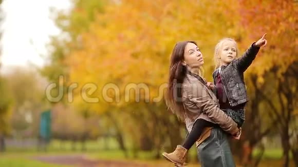可爱的小女孩和妈妈一起享受秋天的户外公园视频的预览图