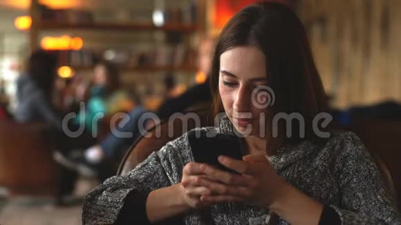 年轻女子坐在咖啡馆里用电话视频的预览图