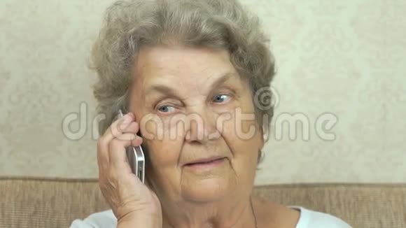 老妇人在家里说智能手机视频的预览图