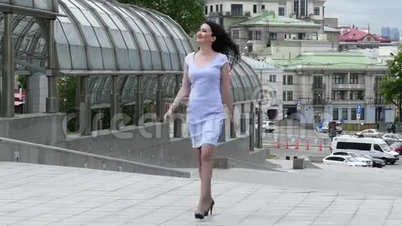 城市背景的漂亮黑发女人视频的预览图