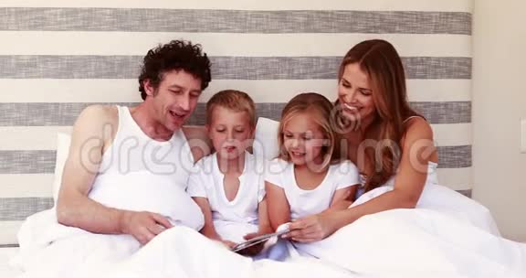 快乐的家庭在床上看书视频的预览图
