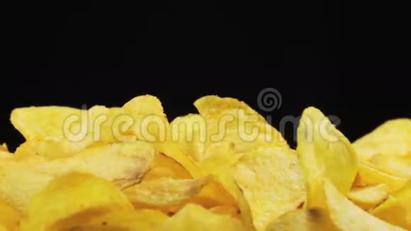 马铃薯芯片在黑色背景上旋转视频的预览图
