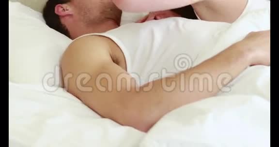 一对恩爱的夫妇躺在床上视频的预览图