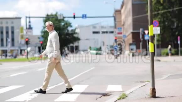 老人沿着城市人行横道行走视频的预览图