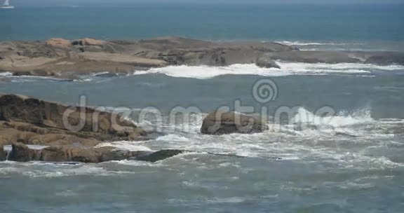 闪闪发光的海洋海水波浪表面和沿海岩石海岸浪涌海岸视频的预览图