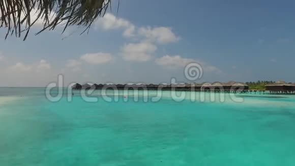热带度假海滩上的平房小屋视频的预览图