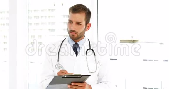 严重的医生在剪贴板上写字视频的预览图