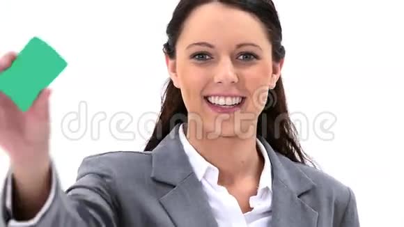微笑的黑发女人拿着名片视频的预览图