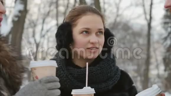 朋友们在冬季公园里聊天喝咖啡视频的预览图