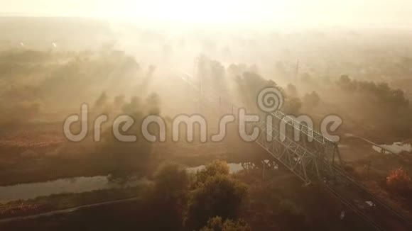 日出时铁路在雾中行驶无人驾驶飞机的视角视频的预览图