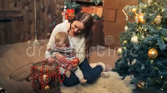 圣诞快乐假日快乐妈妈和女儿在室内装饰圣诞树视频的预览图