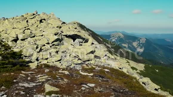 摄像机从喀尔巴阡山脉的峰顶拍摄全景山峦的森林和悬崖斜坡的景色视频的预览图