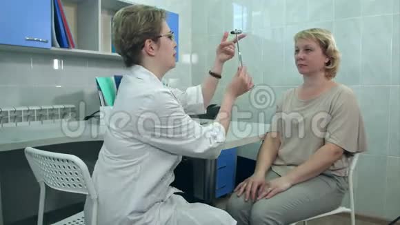 在办公室对一名女性病人进行神经学检查的女性神经学家视频的预览图
