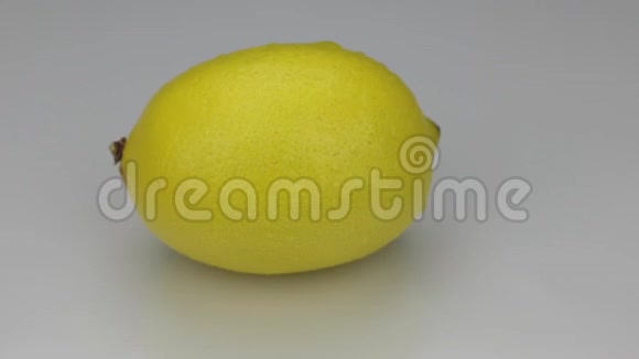 黄色柠檬在白色背景上滴露中旋转视频的预览图
