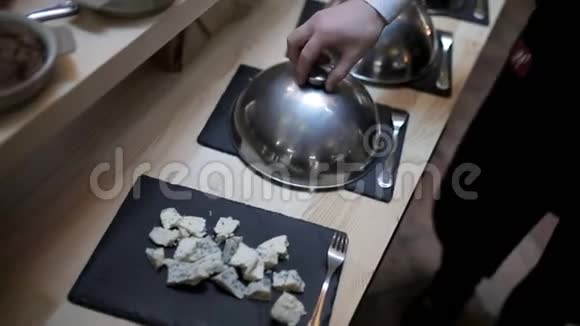 餐厅的自助餐把切好的奶酪和香肠放在盘子里视频的预览图