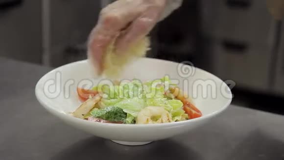 在盘子里用磨碎的奶酪和温热的沙拉煮熟视频的预览图