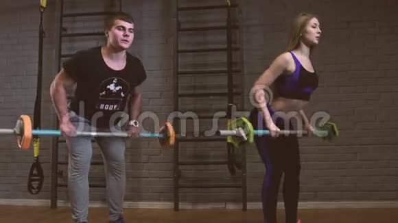 有私人健身教练和杠铃一起锻炼力量体操的女人视频的预览图