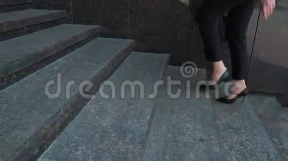 商务女性穿着正式西装走上室外楼梯的下部视频的预览图