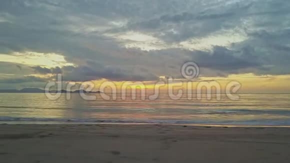 黎明时分沿沙滩边缘及波浪冲刷的飞行摄像机视频的预览图