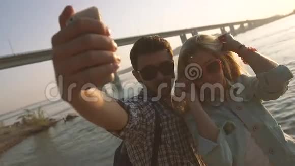 浪漫的年轻夫妇微笑着用手机拍照视频的预览图