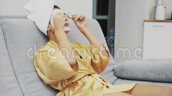 一个漂亮的年轻女人在水疗中心得到一个面罩眼睛里躺着黄瓜很开心而且得到很多视频的预览图