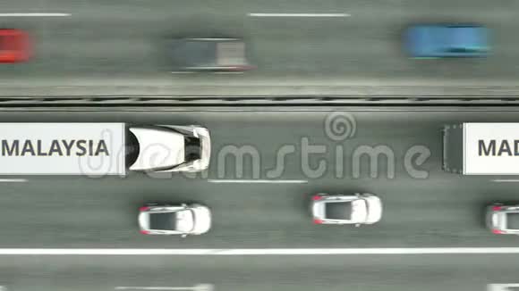 空中俯视的拖车卡车与MADE在马来西亚文字沿道路行驶马来西亚商务相关视频的预览图