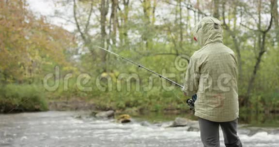 男孩在秋天钓鱼红色镜头视频的预览图