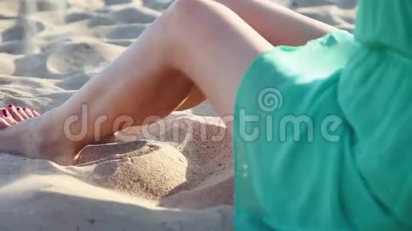 特写镜头美丽的女孩在海滩上玩沙子视频的预览图