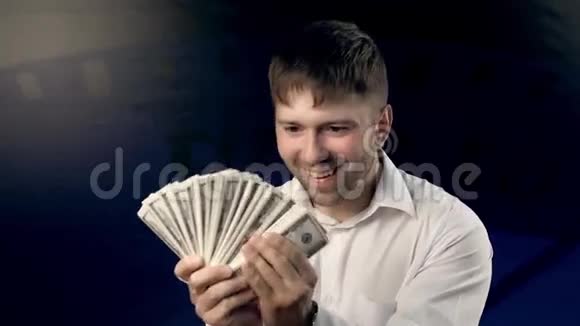 一个快乐的年轻人在赚钱的时候挥挥手视频的预览图