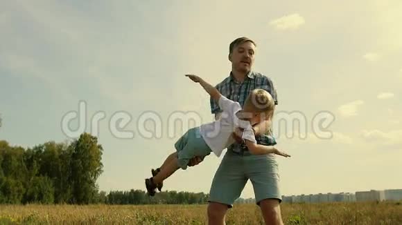 快乐的父亲和儿子一起玩把他抱在怀里男孩想象他像飞机一样飞行视频的预览图