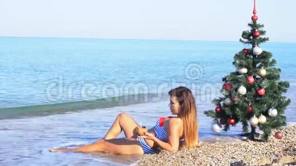 在圣诞节度假胜地海滩上休息的女孩视频的预览图