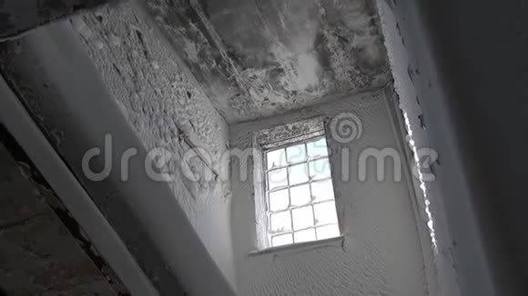 在荒芜的城市里被毁的房子里冰冷的窗户和白雪覆盖的房间视频的预览图