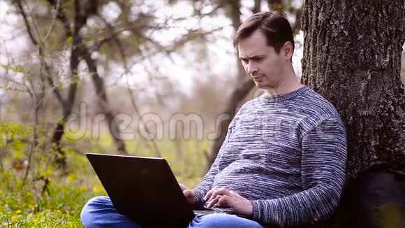 一个男人坐在电脑前打喷嚏视频的预览图