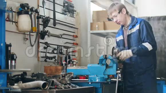 工人在车库工作时的机械手工人打磨金属细节时的圆锯火花把汽车修理捆住视频的预览图
