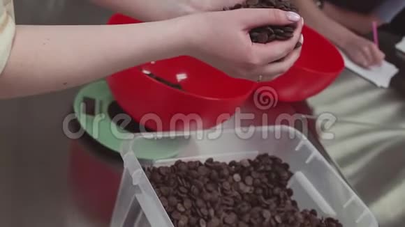 女糖果师把巧克力片放进碗里放在厨房的重量上视频的预览图