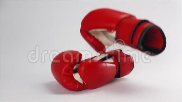 一对红皮拳击手套在白色上脱落和弹跳视频的预览图