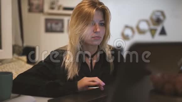 年轻的美女在家里用笔记本电脑视频的预览图