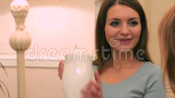 女人给她的朋友提供茶视频的预览图