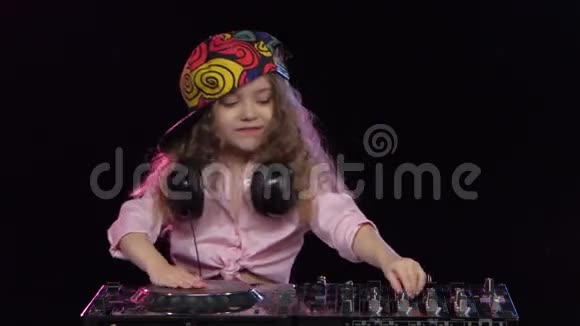 小女孩DJ在明亮的帽子上玩乙烯基工作室视频的预览图