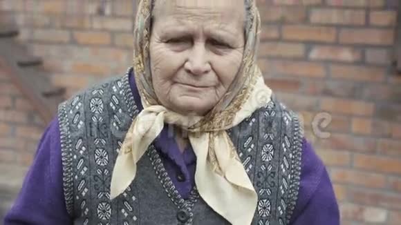 4K镜头中带着悲伤的眼睛微笑的老妇人画像视频的预览图