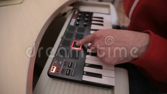 有人在黑色MIDI合成器键盘上使用鼓垫视频的预览图