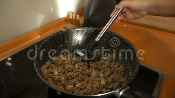 碎肉慢慢掉进厨房的锅里视频的预览图