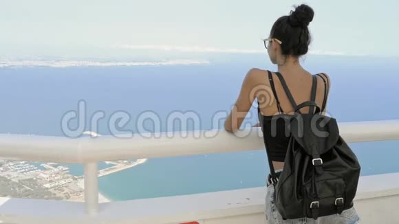 美丽的年轻旅游女孩背包在海边视频的预览图